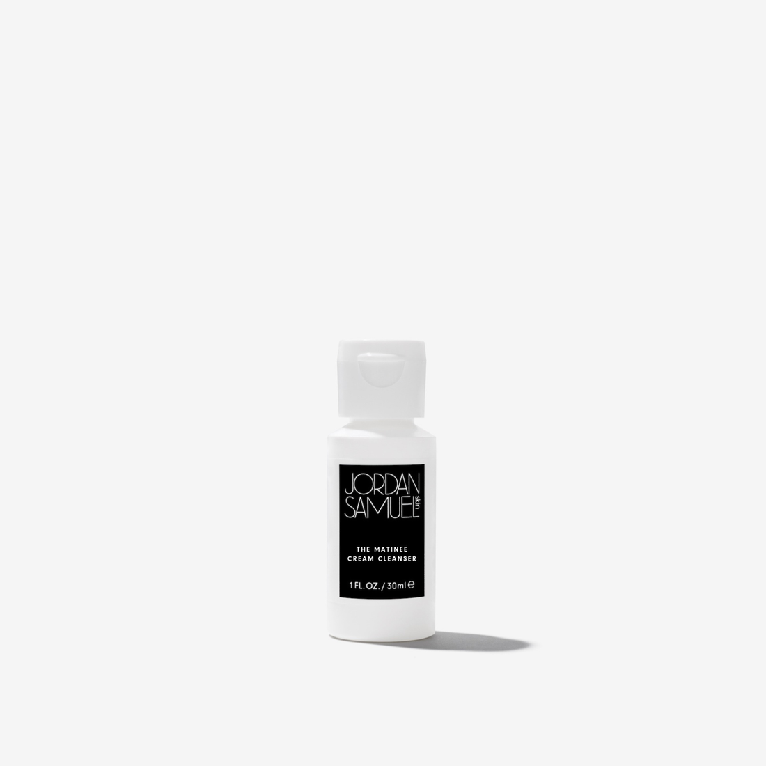 The Matinee Cream Cleanser Mini product image - White squeeze bottle with black label on a white background